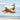 Dog jumping in the air catching a triangular rope toy